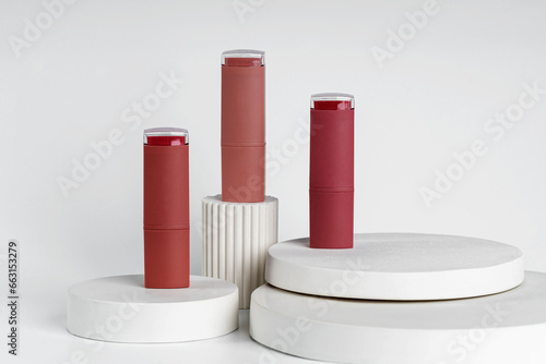 Close-up of Lipsticks With Different Colorful Tones, samples showing on white concrete podiums