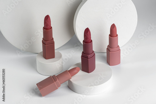 Close-up of Lipsticks With Different Colorful Tones, samples showing on white concrete podiums