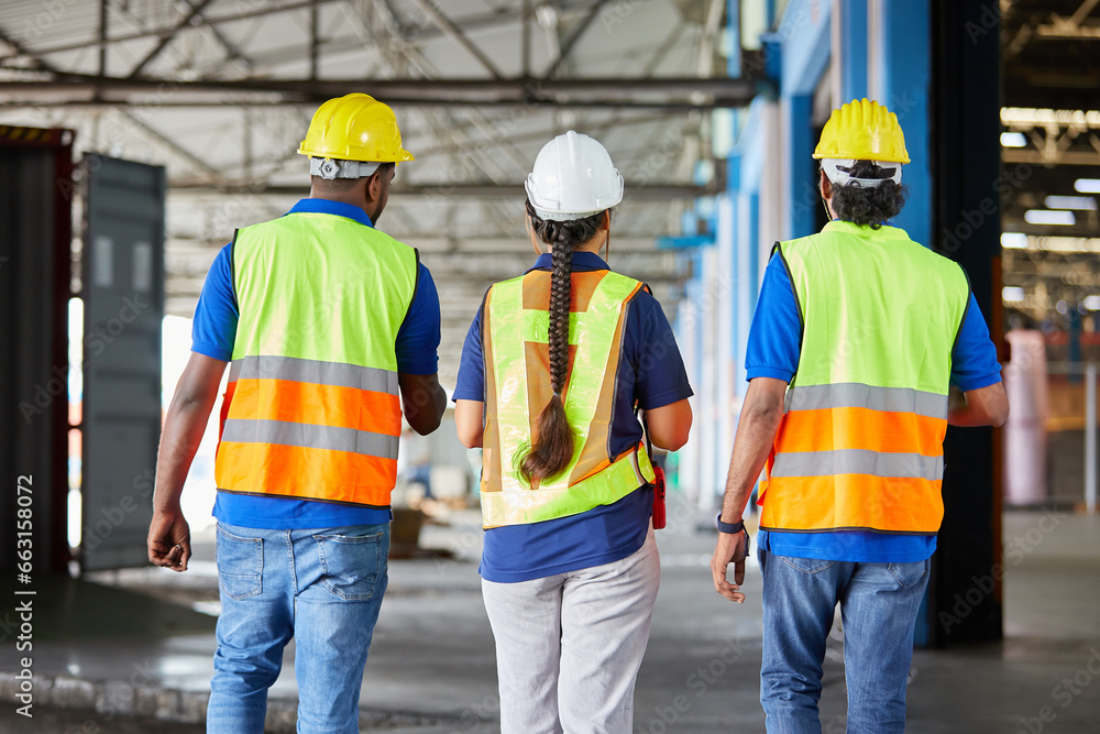 back view workers walking and talking about work or project in the warehouse storage back view workers walking and talking about work or project in the warehouse storage