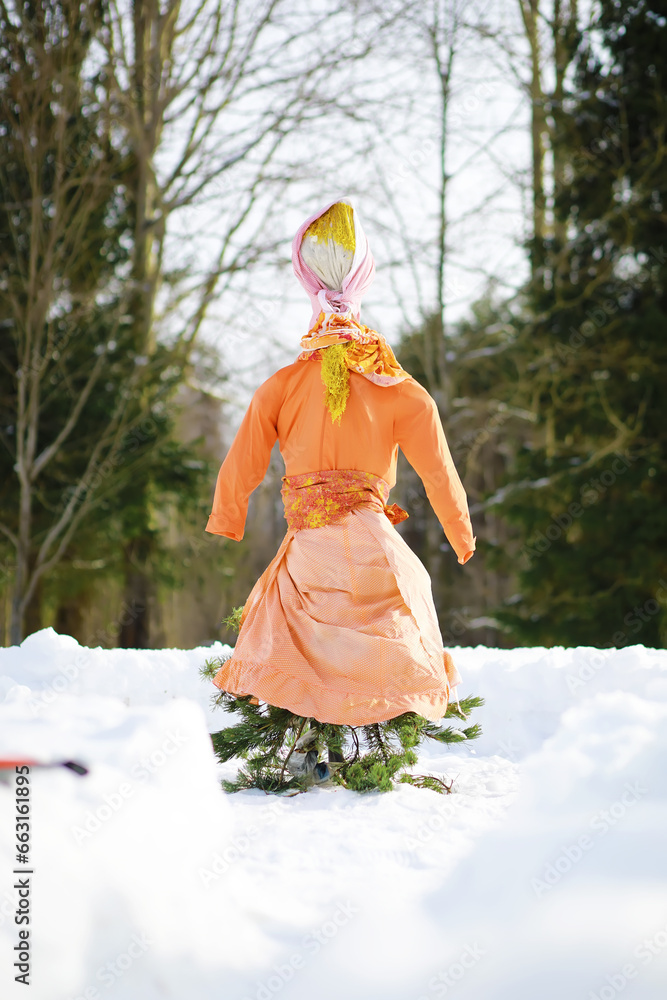 Traditional Russian holiday in early spring. Seeing off winter. Mardi gras. Family with children in the winter in the park. Traditional Russian holiday in early spring. Seeing off winter. Mardi gras. Family with children in the winter in the park.