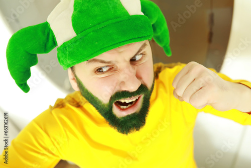 A man with a green beard. St.Patrick 's Day. Irish fan color beard. © alexkich