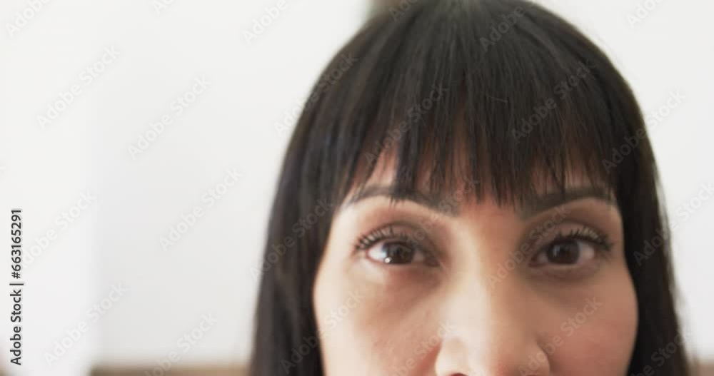 Portrait close up of eyes of happy biracial woman smiling at home, copy space, slow motion Portrait close up of eyes of happy biracial woman smiling at home, copy space, slow motion