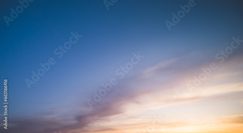 Minimalistic evening sky with clouds and sun glare, looking up at the sky in the evening