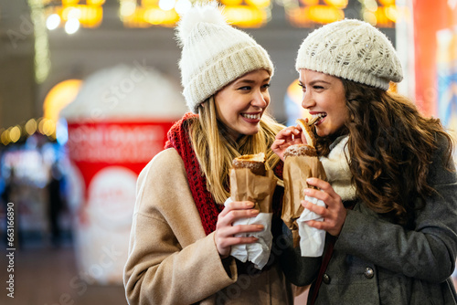 Happy woman friends enjoying time together on christmas market. People happiness concept