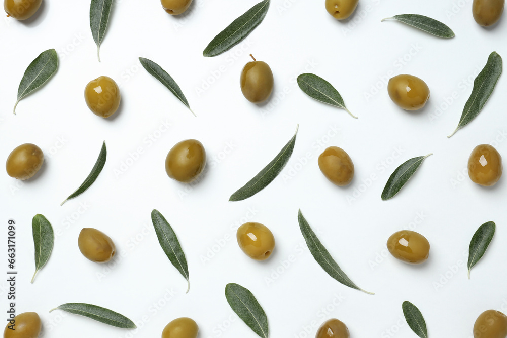 Olives with fresh leaves on a light background Olives with fresh leaves on a light background