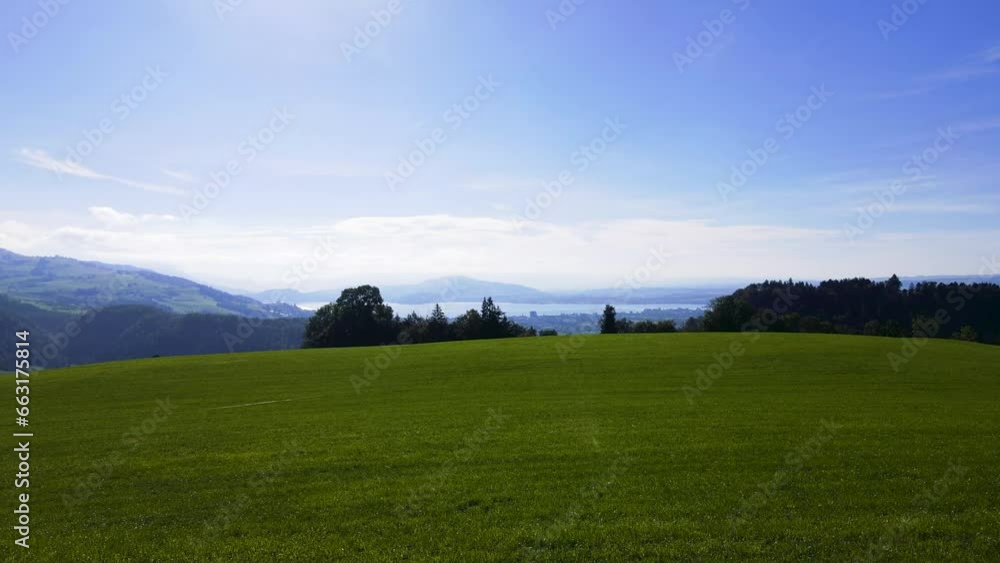 cinematic panoramic view over alpine green sceneries to reveal a majestic Swiss lake and peaceful Swiss town and Swiss forests surround them featuring Mount Rigi and Lake Zug in Switzerland cinematic panoramic view over alpine green sceneries to reveal a majestic Swiss lake and peaceful Swiss town and Swiss forests surround them featuring Mount Rigi and Lake Zug in Switzerland