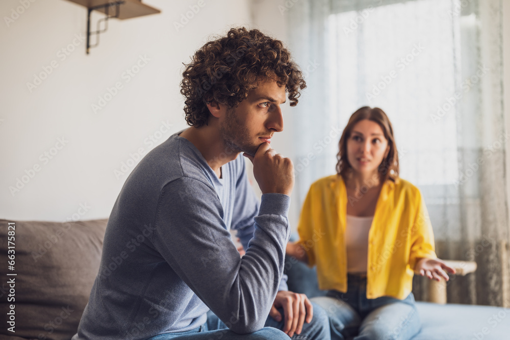 Man and woman are sitting at sofa and arguing. Relationship problems. Man and woman are sitting at sofa and arguing. Relationship problems.