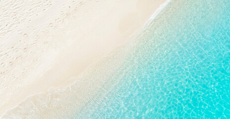Beach Wave water in the Tropical summer beach with  sandy beach background