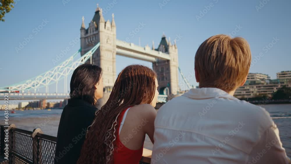 Group of teenagers friends spending time in the main areas of London as the tower bridge. Concept about generation z and friendship Group of teenagers friends spending time in the main areas of London as the tower bridge. Concept about generation z and friendship