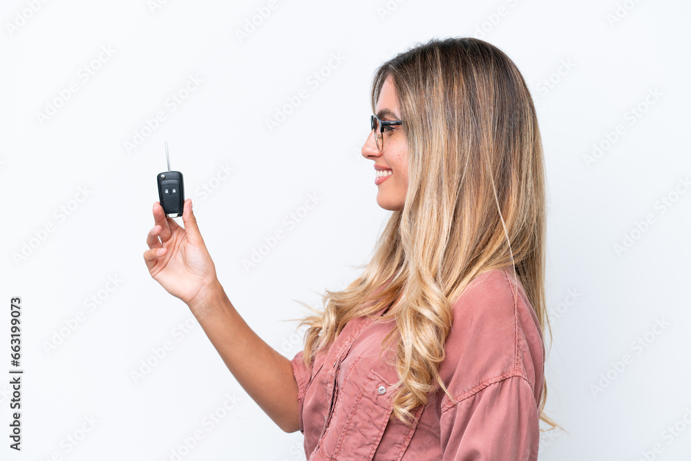 Young pretty Uruguayan woman holding car keys isolated on white background with happy expression Young pretty Uruguayan woman holding car keys isolated on white background with happy expression