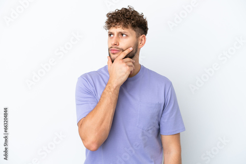 Young handsome caucasian man isolated on white background having doubts