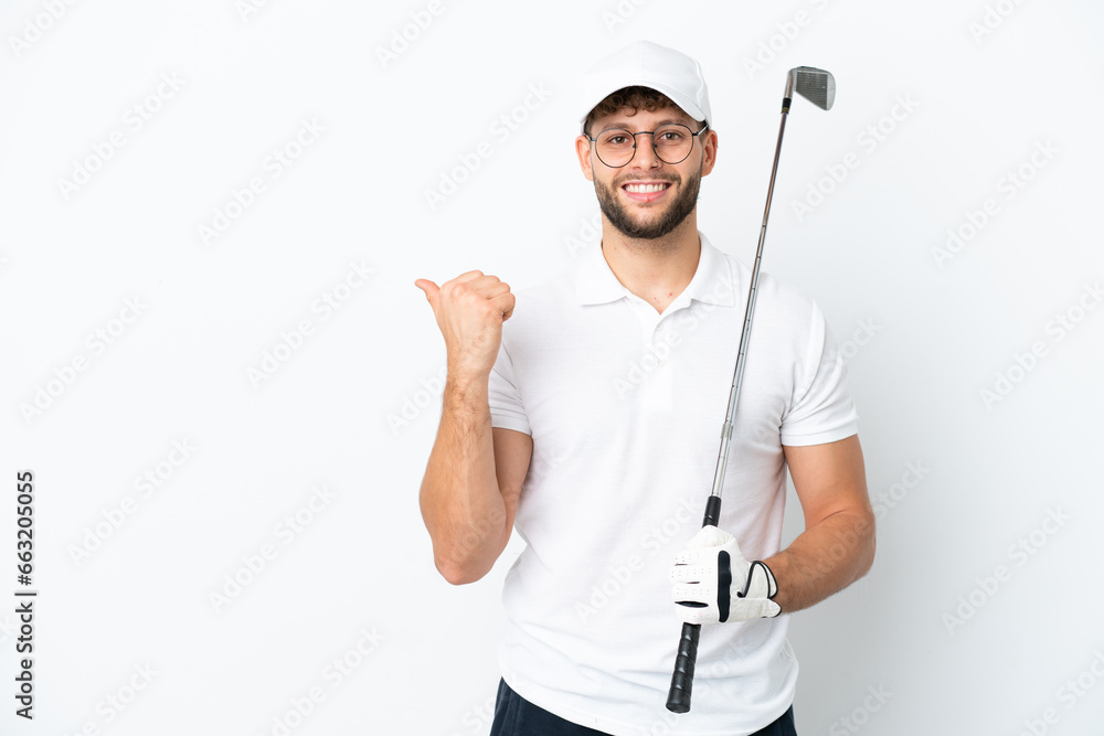 Handsome young man playing golf isolated on white background pointing to the side to present a product Handsome young man playing golf isolated on white background pointing to the side to present a product