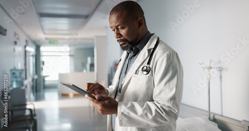 Doctor, hospital and tablet of healthcare information, typing and management of online charts or results. Healthcare worker or african person smile for service, planning or data on digital technology