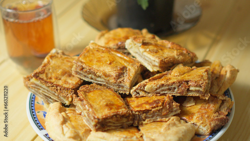 Traditional oriental sweets, baklava on plate folded into pieces.