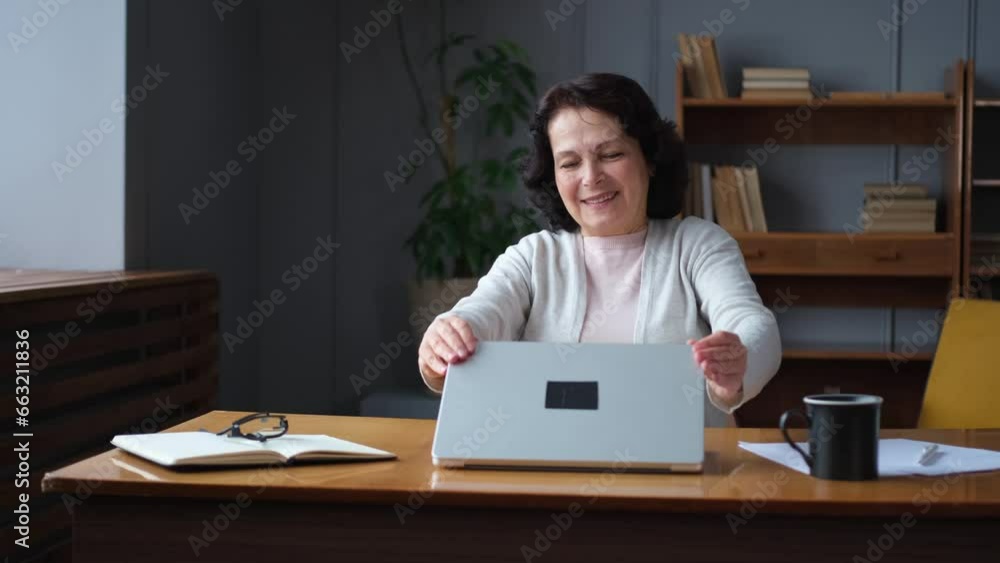 Middle aged senior woman at home closing laptop taking break from work on computer. Older mature woman happy after work done satisfied by good result. Fatigue from long laptop usage Middle aged senior woman at home closing laptop taking break from work on computer. Older mature woman happy after work done satisfied by good result. Fatigue from long laptop usage