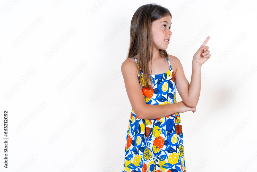 Photo of attractive Beautiful little kid girl wearing colorful dress direct finger empty space cheap dentistry Photo of attractive Beautiful little kid girl wearing colorful dress direct finger empty space cheap dentistry