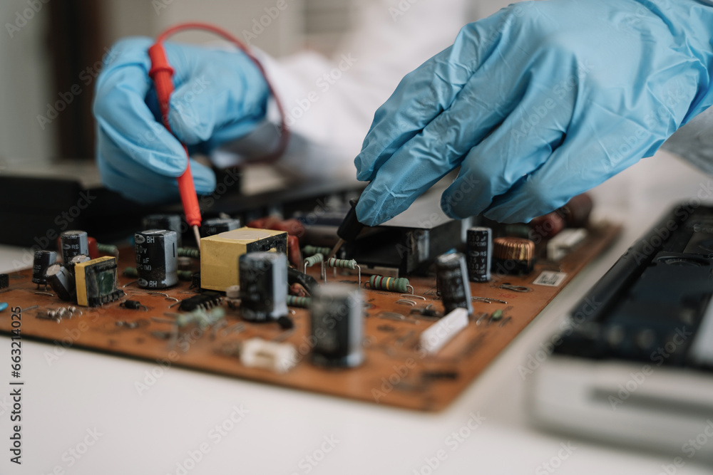Hands repairing electronic devices. Electronic technician. Hands repairing electronic devices. Electronic technician.