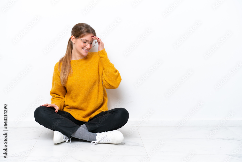 Young caucasian woman sitting on the floor isolated on white background laughing Young caucasian woman sitting on the floor isolated on white background laughing