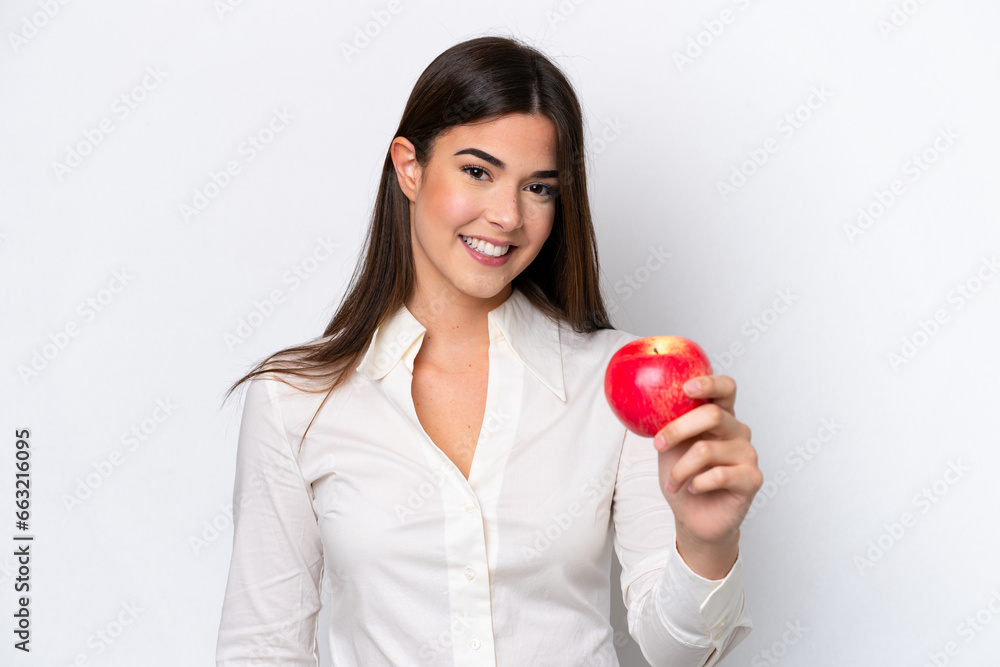 Young Brazilian woman with an apple isolated on white background with happy expression Young Brazilian woman with an apple isolated on white background with happy expression