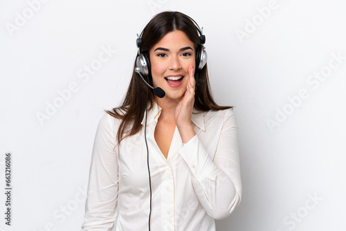 Telemarketer caucasian woman working with a headset isolated on white background shouting with mouth wide open