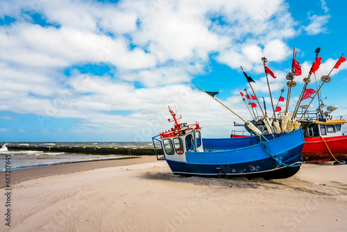 Beach near Niechorze in Poland. Natural coast on the Polish Baltic Sea with white sand and fishing boats. Landscape by the sea. photo