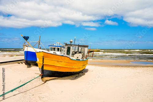 Beach near Niechorze in Poland. Natural coast on the Polish Baltic Sea with white sand and fishing boats. Landscape by the sea.