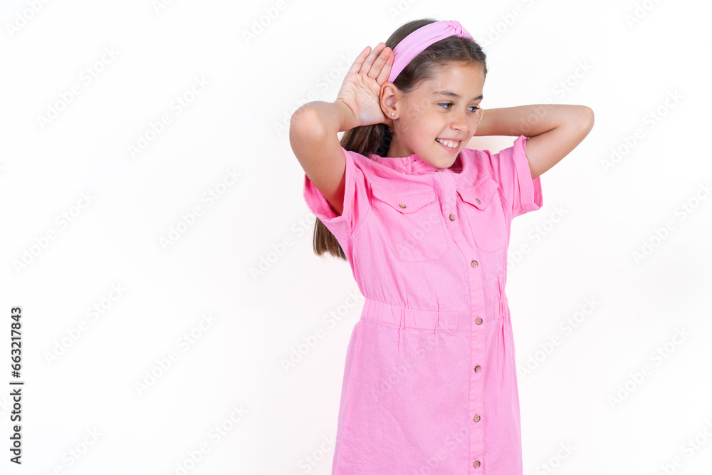 Beautiful little kid girl wearing pink dress Trying to hear both hands on ear gesture, curious for gossip. Hearing problem, deaf Beautiful little kid girl wearing pink dress Trying to hear both hands on ear gesture, curious for gossip. Hearing problem, deaf
