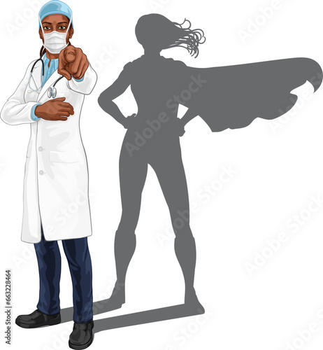 A super hero black woman female doctor medical healthcare health professional in mask PPE pointing. Revealed to be a superhero by her shadow.