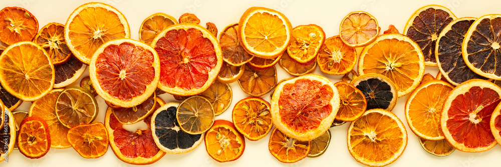 Fototapeta premium Banner of dried citrus, fruits sliced orange and tangerine, lime and lemon, kumquat and grapefruit slices , preparation for the celebration of Christmas, copy space