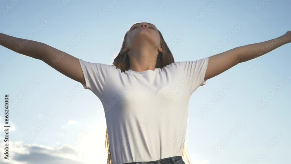 Happy celebration of victory success of young woman against background sky with her hands raised above her head. Achieve dream success. Delight young woman with happiness. Raising up his hands in sky Happy celebration of victory success of young woman against background sky with her hands raised above her head. Achieve dream success. Delight young woman with happiness. Raising up his hands in sky