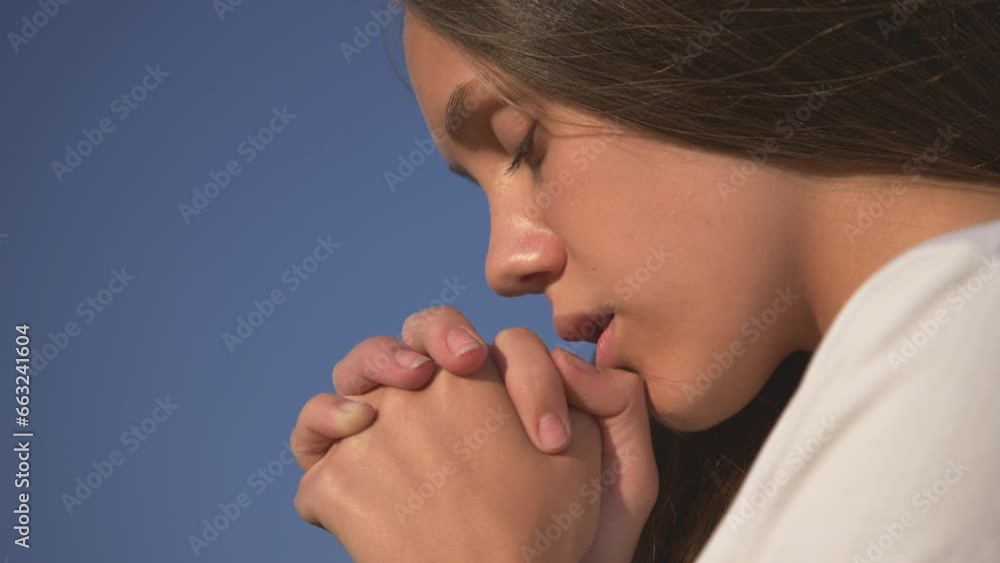 girl closed her eyes, praying to heaven.Hands folded in prayer faith concept.concept of peace, hope, dreams. Spiritual face of young white girl praying with hope, eyes closed, hands folded in prayer. girl closed her eyes, praying to heaven.Hands folded in prayer faith concept.concept of peace, hope, dreams. Spiritual face of young white girl praying with hope, eyes closed, hands folded in prayer.