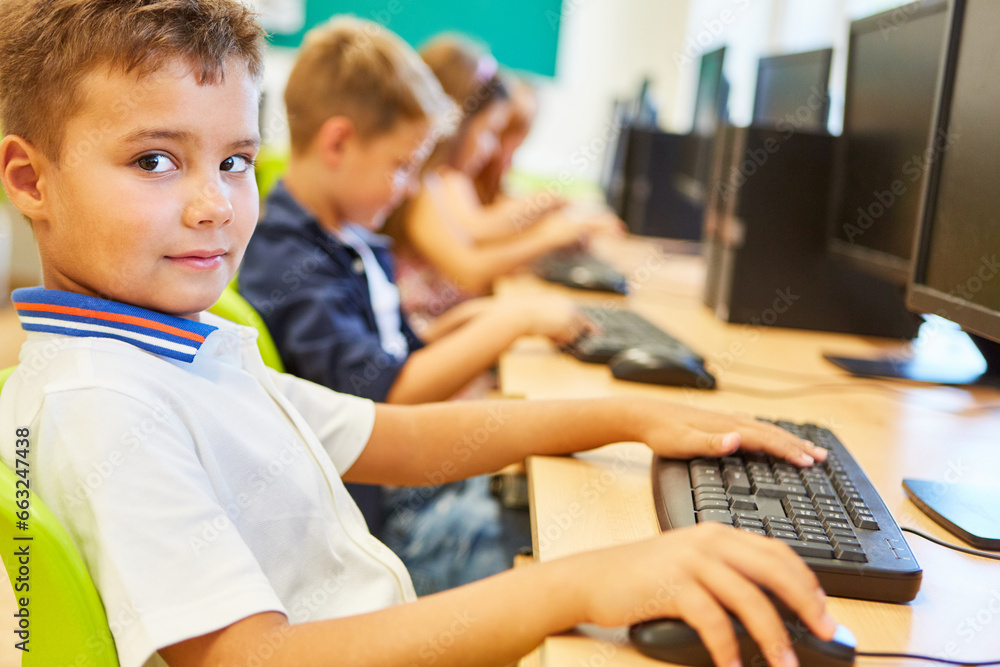 Boy sitting at desk in computer class Boy sitting at desk in computer class