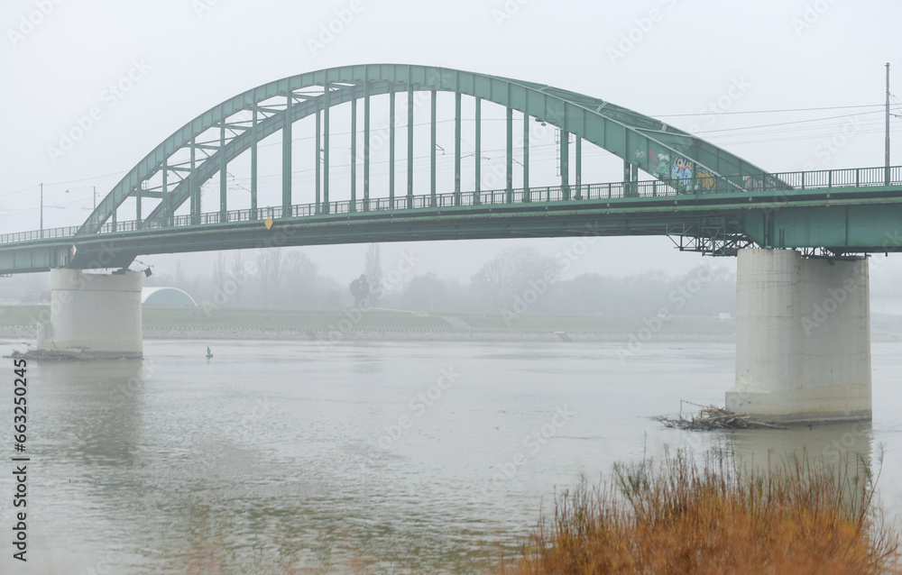 Old bridge across Sava river in Belgrade in a cloudy day.