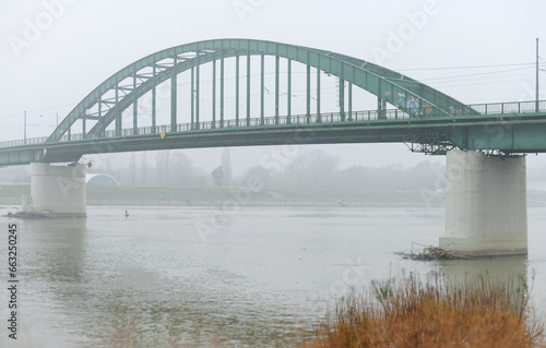 Old bridge across Sava river in Belgrade in a cloudy day.