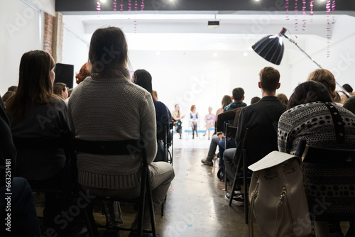 People are sitting with their backs to the audience.Unrecognizable people sitting at a lecture or meeting at the university. business and entrepreneurship or the concept of learning.High quality photo