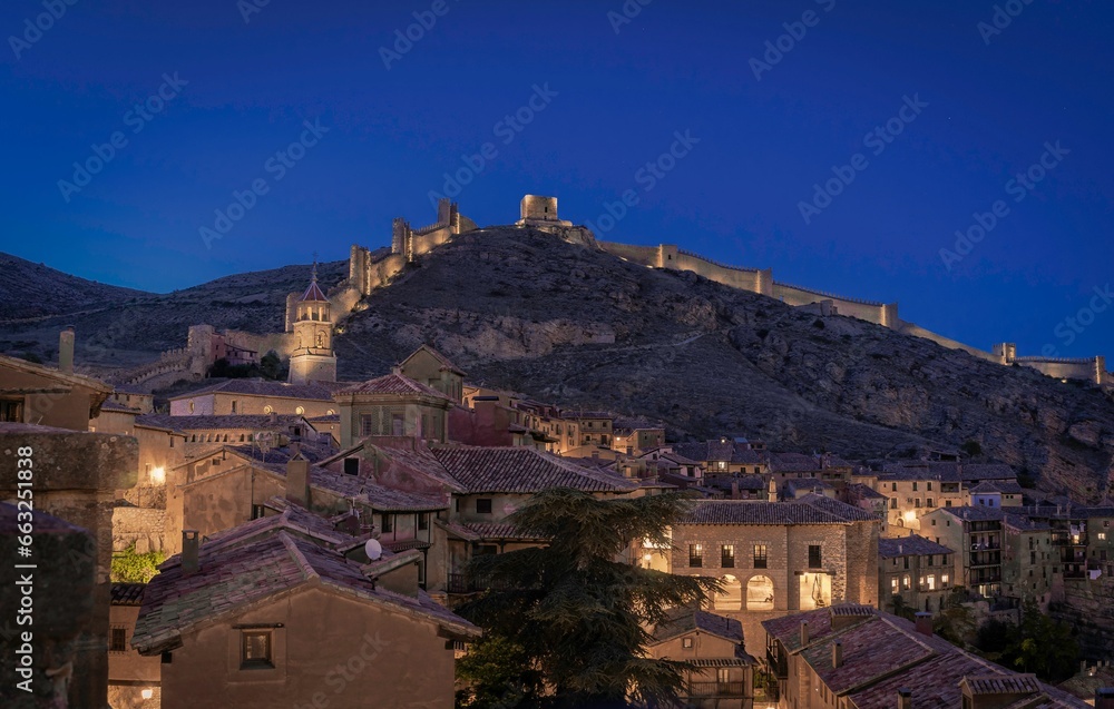 Wall of the medieval town of albarracin illuminated at night. Teruel. Spain.