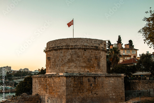 Hidirlik Tower is a symbolic tower made of yellowish brown stone in Antalya, where Kaleici meets Karaalioglu Park. photo
