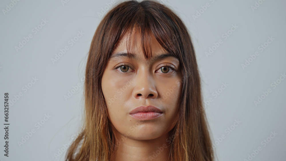 Beautiful person look at camera close up. Young adult woman face portrait. Stylish 30 years old girl on isolated white background. Attractive female feminism model. Modern millennial feminist people. Beautiful person look at camera close up. Young adult woman face portrait. Stylish 30 years old girl on isolated white background. Attractive female feminism model. Modern millennial feminist people.