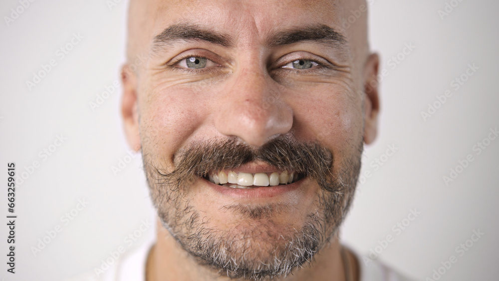 Fototapeta premium Handsome person look at camera close up. Young adult man face portrait. Stylish 30s guy on isolated white background. Attractive male model. Modern millennial people. Brutal bearded style. Barber shop