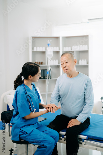 Female doctor holding male patient hand on the bed with receiving saline solution in hospital or clinic..