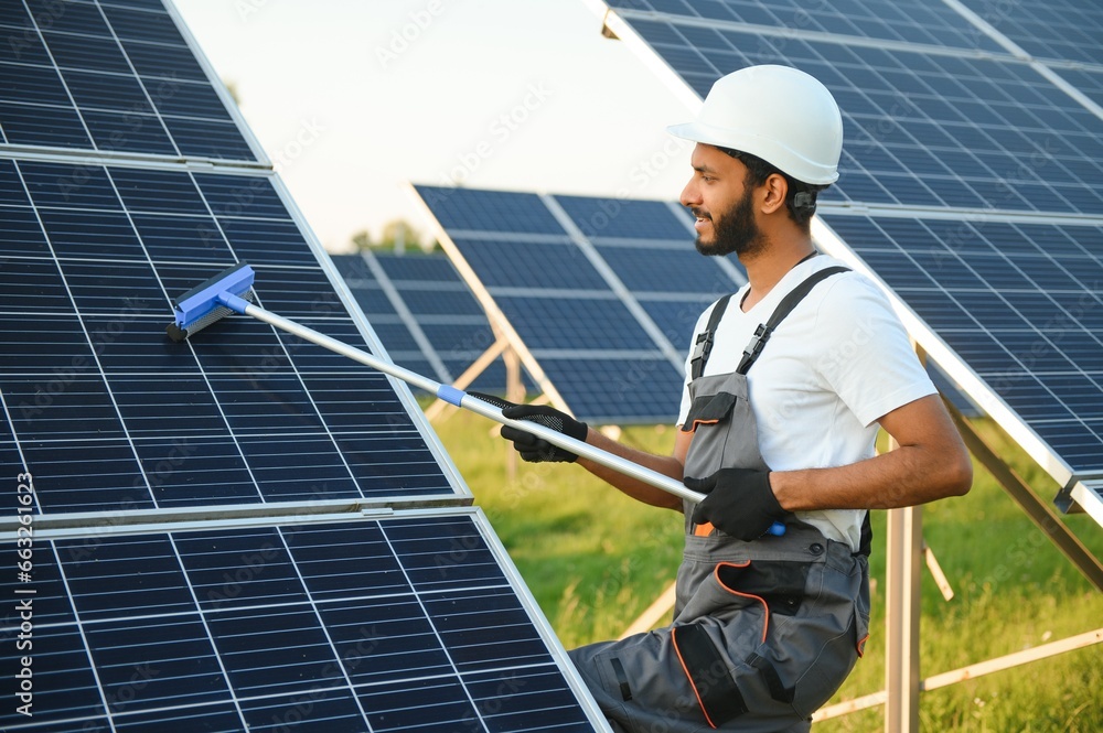 Indian man in uniform working near solar panel. Indian man in uniform working near solar panel.