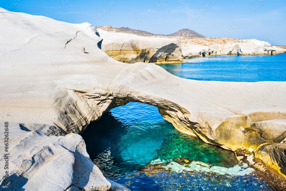 Famous cave at rocky beach of Sarakiniko with crystal clear sea water bay, Milos island, Cyclades, Greece