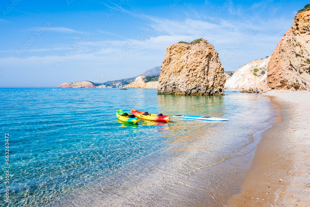 Kayaks on beautiful sandy Fyriplaka beach with azure sea water, Milos island, Cyclades, Greece