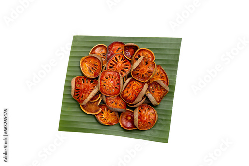 Dried bael fruit slices on white background. photo