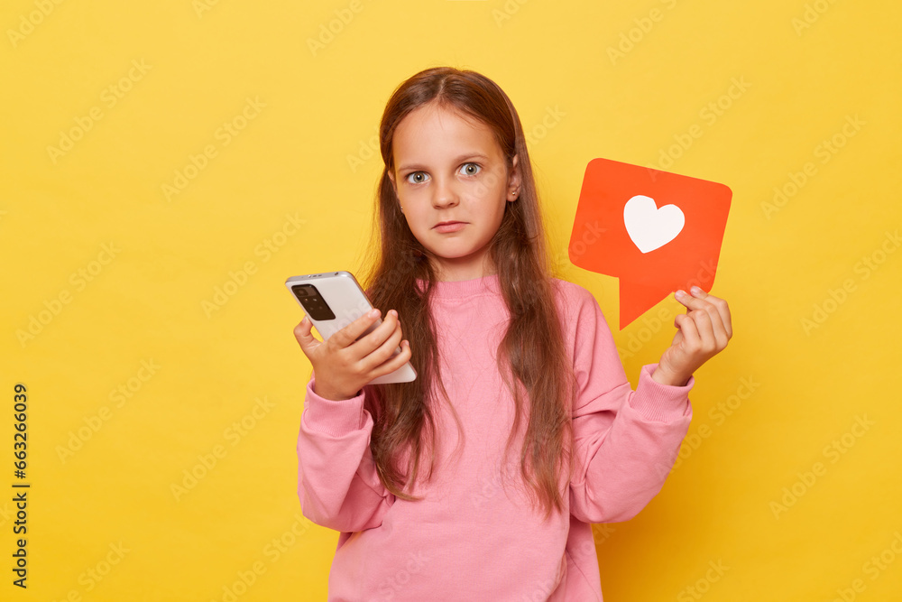 Engaging with social media content shocked brown-haired young girl in pink sweatshirt explores internet viewing various online materials expresses appreciation by clicking on heart icon. Engaging with social media content shocked brown-haired young girl in pink sweatshirt explores internet viewing various online materials expresses appreciation by clicking on heart icon.