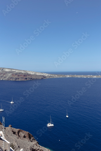 Some boats on a tiny dock in a cliff in Santorini, Mediterranean Sea, Greece
