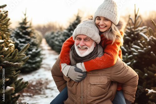 happy smiling grandfather and child with snow in forest