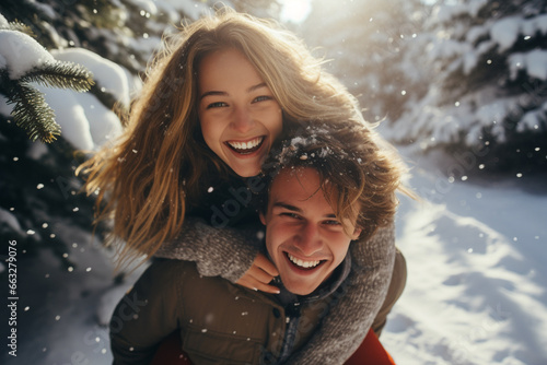 happy smiling portrait of a couple wearing warm clothes in winter forest