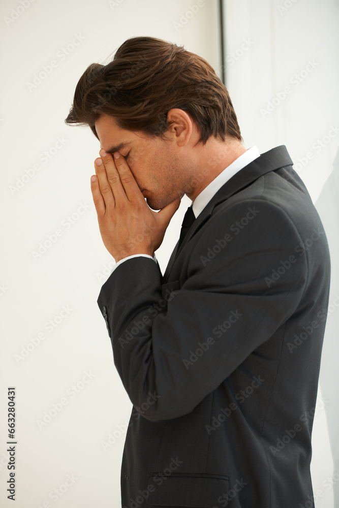 Stress, anxiety and business man in office with fear, worry or desperate prayer for help on wall background. Nervous, mistake and profile of male manager with headache for startup, disaster or fail Stress, anxiety and business man in office with fear, worry or desperate prayer for help on wall background. Nervous, mistake and profile of male manager with headache for startup, disaster or fail