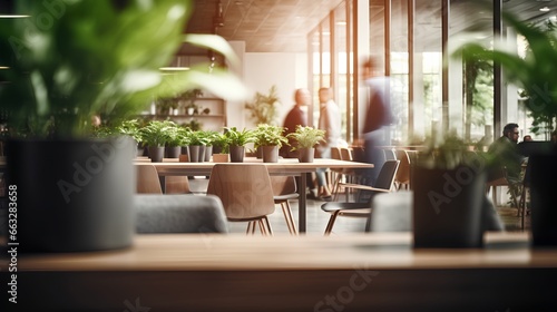 Modern office space with wooden furniture and plants in pots. Innovative startup company with green, ecofriendly environment with lush vegetation in workplace. Productive and healthy work place.